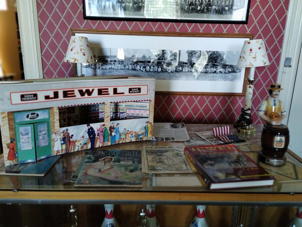 Photograph featuring Jewel merchandise and trophies in the main room of the Kincaid House.